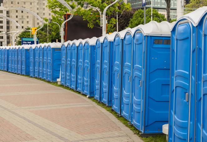 a row of portable restrooms at an outdoor special event, ready for use in Arab